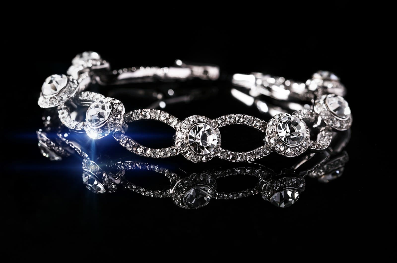 A diamond bracelet catching light against black.